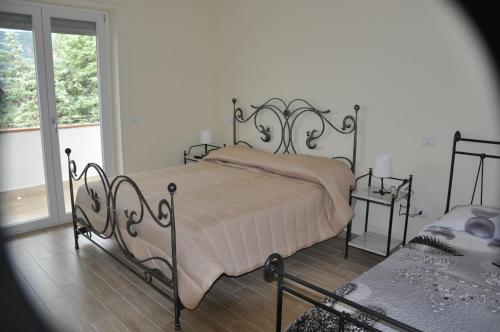 a bedroom with a bed and a window at La Vecchia Lanterna in Montecorvino Rovella
