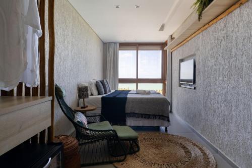 a hotel room with a bed and a window at Mansão Vista de 180º para Mar na Rota dos Milagres in Passo de Camarajibe
