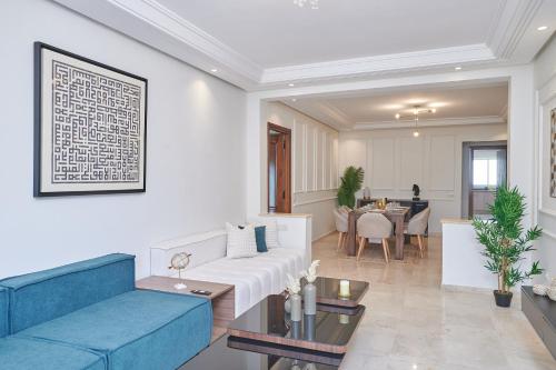 a living room with a blue couch and a table at YourPlace Rabat Agdal 1 - Cozy Residence in Rabat