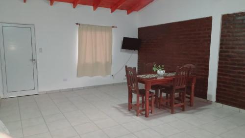 a dining room with a wooden table and chairs at Mi sueño in San Antonio Oeste