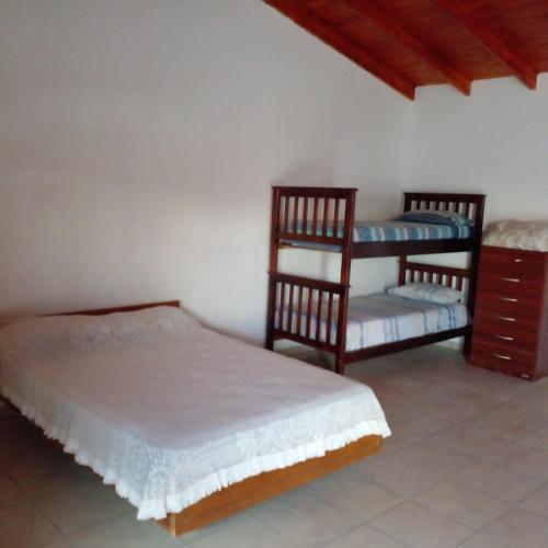 a bedroom with two twin beds and a chair at Mi sueño in San Antonio Oeste