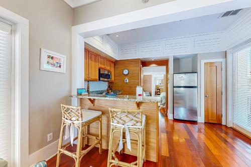 a kitchen with a bar and two stools at Sunshine Haven in Carrabelle