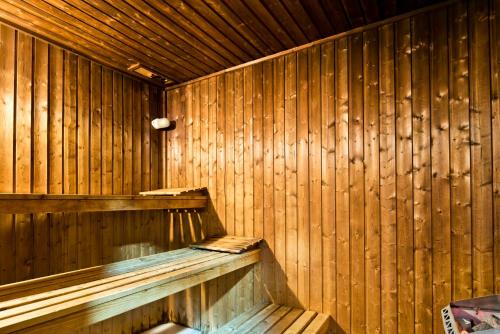 a wooden sauna with a wooden wall at Golden Tulip Porto Gaia in Vila Nova de Gaia