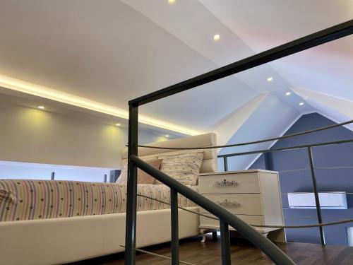 a bedroom with a bed and a glass railing at Banićević APARTMANI in Ðenovići