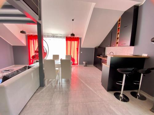 a kitchen and dining room with a table and chairs at Banićević APARTMANI in Ðenovići