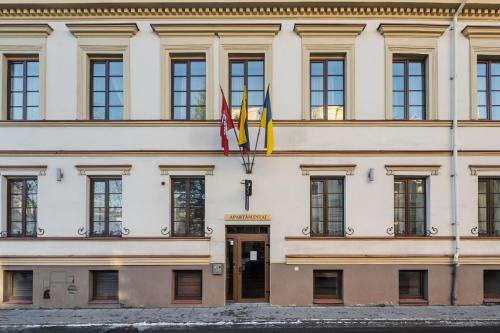 a building with two flags in front of it at CATHEDRAL Old Town Suites in Vilnius