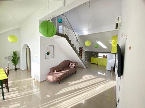 a living room with a couch and a staircase at Banićević APARTMANI in Ðenovići