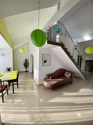a living room with a couch and a table and a staircase at Banićević APARTMANI in Ðenovići