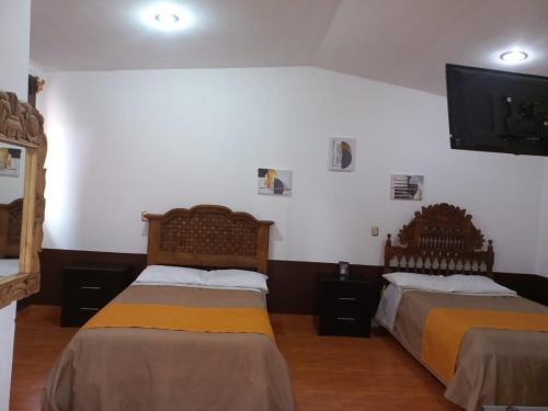 Postel nebo postele na pokoji v ubytování Hotel Alameda Maravatio