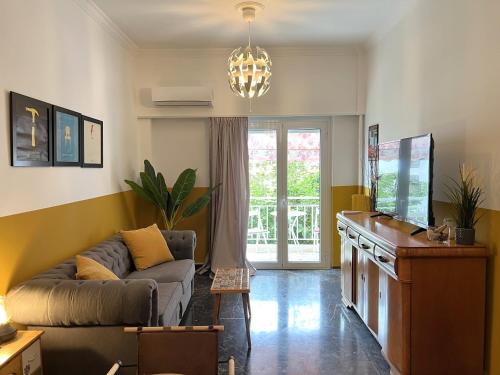 a living room with a couch and a table at Athenian Vintage Style 2 bdr apartment in Athens
