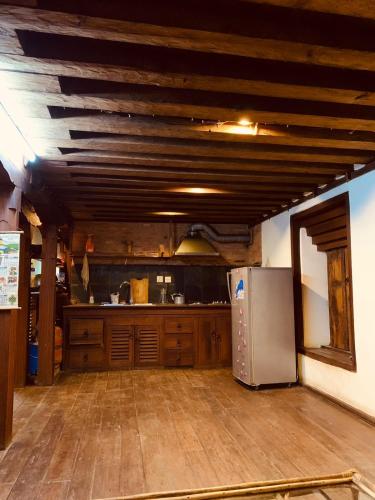 a kitchen with wooden floors and a refrigerator at Traditional Nepali Style 1 & 2 BHK Apartments, Humble Home, Patan in Pātan