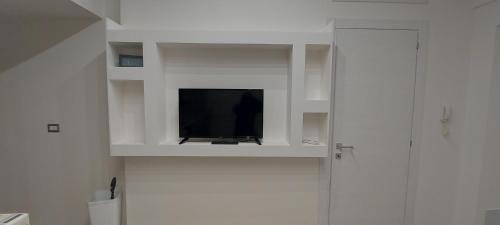 a television in a white cabinet in a bathroom at La Maison d'Annette in Lavello