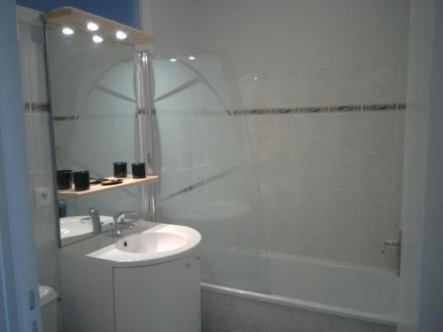 a white bathroom with a sink and a shower at Ker anna in Séné