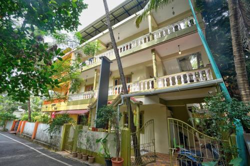 a building with a balcony on the side of a street at Hotel Leela Inn Candolim in Marmagao