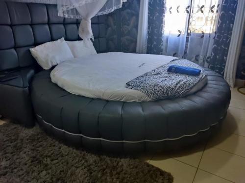 a bed in a room with a bean bag chair at 2BR Shanzu Serena in Mombasa