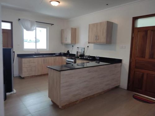 a kitchen with a large island in the middle at 2BR Shanzu Serena in Mombasa
