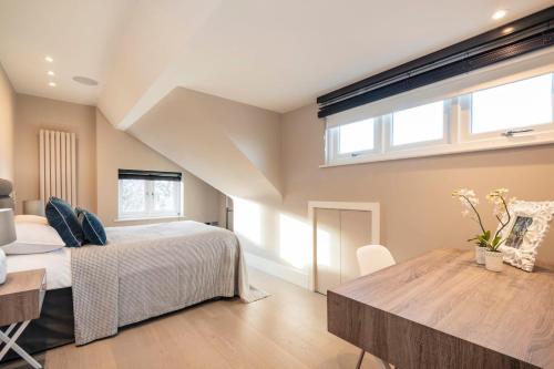 sypialnia z łóżkiem i drewnianym stołem w obiekcie Hampstead Luxury Flat-Hosted by Sweetstay w Londynie