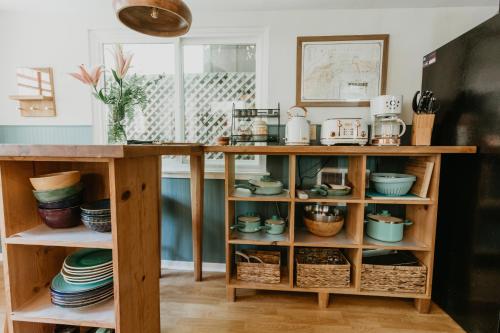a kitchen with a wooden counter with bowls and dishes at Moonrise on Mill St. Inn- Carriage Haus in Nevada City