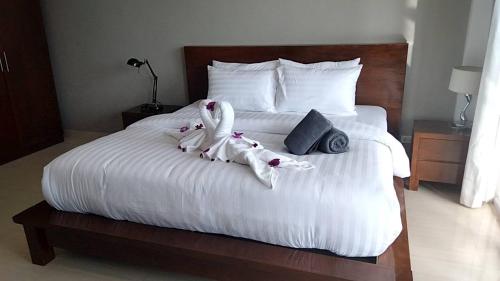 a bedroom with a bed with two swans on it at 2 Bedroom Seaview Lanta Sport Resort 303 in Phra Ae beach