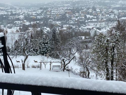 a view of a snow covered city from a balcony at Mieszkanko z tarasem in Limanowa