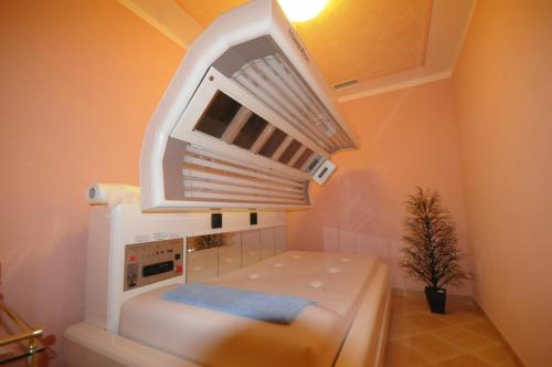 a room with a white kitchen with a microwave at Sporting Hotel in Passo del Tonale