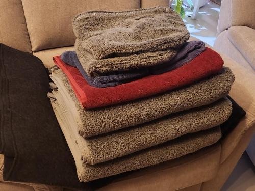 a pile of blankets sitting on top of a couch at Inspiring Apartment near city center in Mikkeli