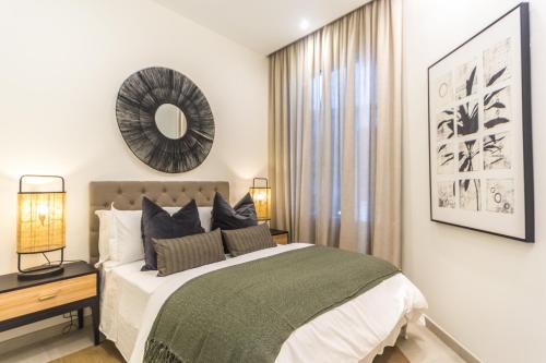 a bedroom with a bed and a mirror on the wall at CASONA 6 LUNAS APART Ba-BA1 in Marbella