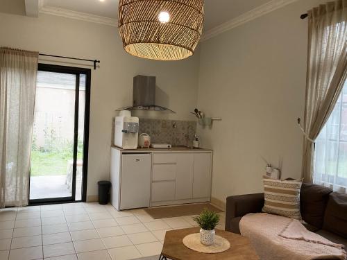 CinengangirangThe Pinewood House Villa Kota Bunga by Citrus House的配有沙发和桌子的厨房和客厅