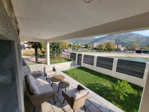 a patio with chairs and a view of a yard at Vila Petra in Trebinje