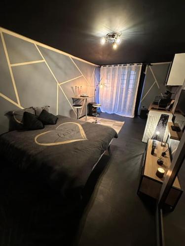 a bedroom with a large bed and a desk at The MiniDream 07 in Tournon-sur-Rhône