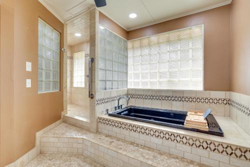 a large bathroom with a tub and a window at San Antonio Home Private Pool and Covered Patio in San Antonio
