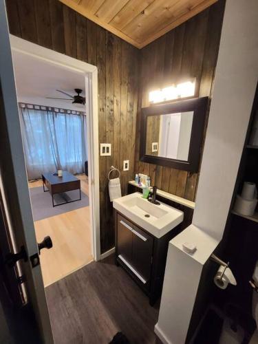 a bathroom with a sink and a mirror at Foresight Chalet Laidlaw in Timmins