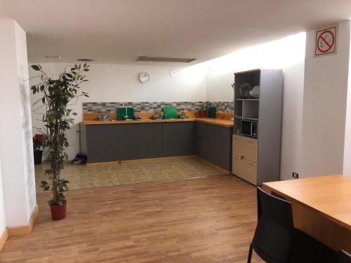 a large kitchen with a counter and a refrigerator at Urban rest zone and coworking in Arrecife