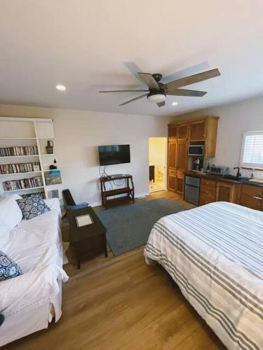 a bedroom with a bed and a ceiling fan at OB Paradise in San Diego