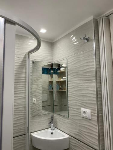 a bathroom with a sink and a mirror at La Piccola Mole - Turin Cozy Apartment in Turin