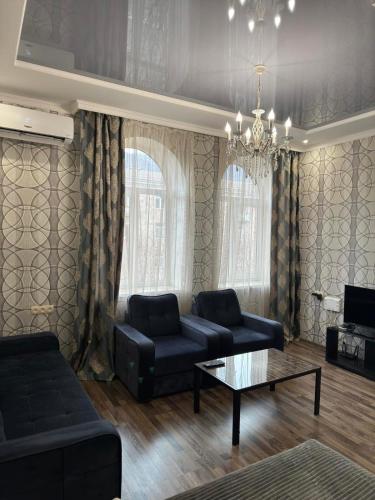 a living room with a couch and a coffee table at Комфортная квартира в центре in Vanadzor