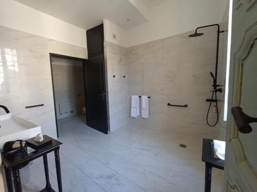 a bathroom with a shower and a toilet and a sink at Mercure Figeac Viguier du Roy in Figeac