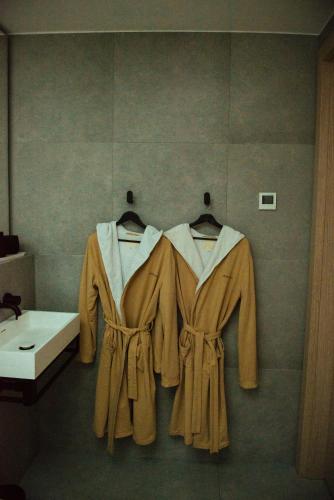 a bathroom with two robes hanging on a wall at Jägala Juga Nature Resort SPA in Jägala-Joa
