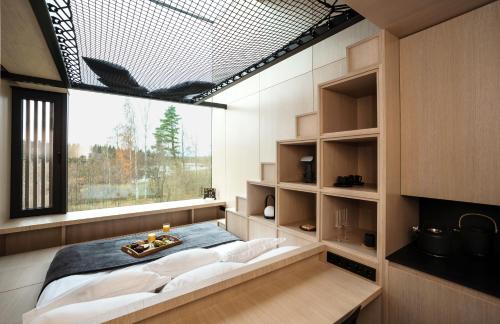 a bedroom with a bed and a large window at Jägala Juga Nature Resort SPA 