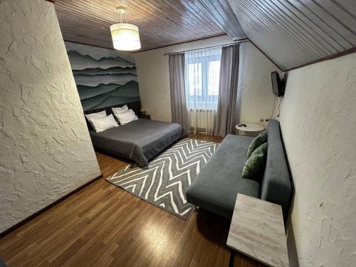 a small room with a couch and a bed in it at Зоряні Карпати in Slavske