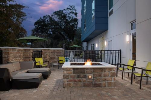 a patio with a fire pit in the middle of a building at SpringHill Suites By Marriott Charleston Airport & Convention Center in Charleston
