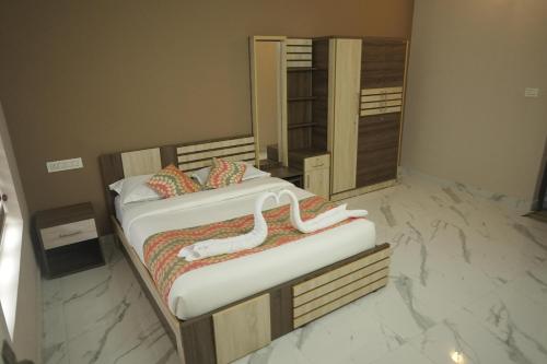 two beds in a bedroom with a marble floor at Luxe Hotel - Rooms & Villas Wayanad in Wayanad