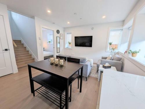 a living room with a table and a couch at Centrally located, modern, 2 bedroom home in Vancouver