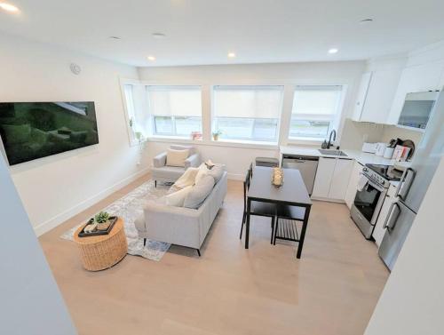 a living room with a couch and a table at Centrally located, modern, 2 bedroom home in Vancouver