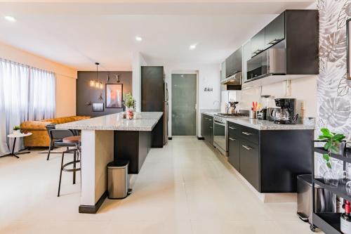 an open kitchen and living room with a large island at NEW Great Stay in Roma 24-7 Security in Mexico City