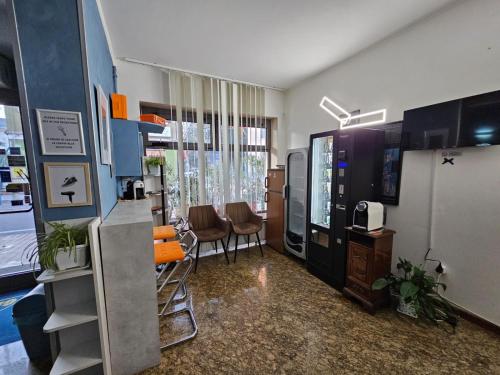 a room with a living room with chairs and a kitchen at Hotel Giovannina in Mestre