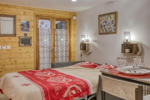 um quarto com uma cama e uma mesa com pratos em Studio "Cosy" hyper centre em Saint-Gervais-les-Bains