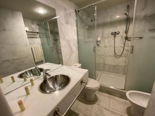 a bathroom with a sink and a shower and a toilet at Hostatgeria de Poblet in Poblet