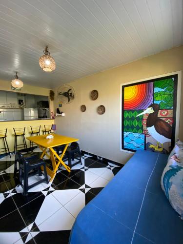 a room with a table and a dining room at Casa Silveira NORONHA in Fernando de Noronha