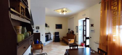 a living room with a couch and a table at casa vacanze “Tra cielo e mare” Agerola in Agerola